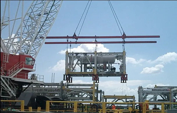 Crane lifting a process module into a refinery pipe rack