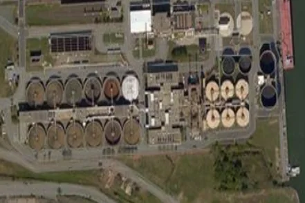 Aerial view of wastewater treatment clarifiers and process buildings
