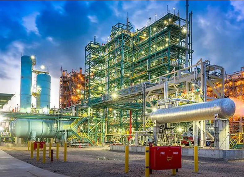 Chemical process unit and pipe rack lit at dusk